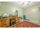 A well-lit bedroom with light green walls and hard surface floors at 5848 Kingswood Ct, Norcross, GA 30093