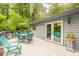 Outdoor deck with dining and lounge furniture for entertaining, alongside french doors at 5848 Kingswood Ct, Norcross, GA 30093