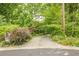 Long driveway, leading to a serene, tree-lined property with established landscaping and privacy at 5848 Kingswood Ct, Norcross, GA 30093