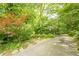 The long driveway offers privacy to this home nestled among mature trees and lush landscaping at 5848 Kingswood Ct, Norcross, GA 30093