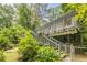Exterior view of a multi-level home with a staircase and lush landscaping at 5848 Kingswood Ct, Norcross, GA 30093