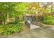 Charming home featuring a ramp walkway, stone accents, and lush landscaping, creating an inviting entrance at 5848 Kingswood Ct, Norcross, GA 30093