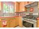A charming kitchen features wood cabinets, red countertops, and stainless steel appliances at 5848 Kingswood Ct, Norcross, GA 30093