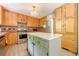 Functional kitchen with a center island, stainless steel appliances, and ample cabinetry at 5848 Kingswood Ct, Norcross, GA 30093