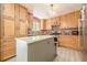 Bright kitchen featuring a center island, wood cabinets, and black and white backsplash at 5848 Kingswood Ct, Norcross, GA 30093