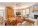 Cozy living room featuring a stone fireplace and large windows with natural light at 5848 Kingswood Ct, Norcross, GA 30093