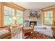 Charming living room with a stone fireplace and large windows showcasing outdoor views at 5848 Kingswood Ct, Norcross, GA 30093