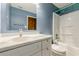 This bathroom showcases a sleek vanity, full mirror, and a modern shower-tub combo at 5868 Kingswood Nw Ct, Norcross, GA 30093