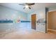 This bedroom features a ceiling fan, window, and dinosaur wall decor, great for  at 5868 Kingswood Nw Ct, Norcross, GA 30093