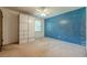 Bedroom featuring a blue accent wall, carpeted floors, and built-in closet at 5868 Kingswood Nw Ct, Norcross, GA 30093