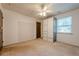 This bedroom offers neutral walls, ceiling fan, window and closet perfect for customization at 5868 Kingswood Nw Ct, Norcross, GA 30093