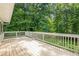 Expansive wooden deck providing ample space with lush trees providing privacy and shade at 5868 Kingswood Nw Ct, Norcross, GA 30093
