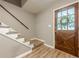 Charming entryway featuring a wooden front door with glass and adjacent staircase with wooden steps at 5868 Kingswood Nw Ct, Norcross, GA 30093
