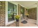 Welcoming entryway with potted plants flanking the front door and a brick facade at 5868 Kingswood Nw Ct, Norcross, GA 30093