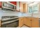 Updated kitchen featuring stainless steel appliances, granite countertops, and custom cabinets at 5868 Kingswood Nw Ct, Norcross, GA 30093
