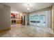 Open kitchen with stainless steel appliances, tile flooring and adjacent sunroom access at 5868 Kingswood Nw Ct, Norcross, GA 30093