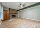 Living room with a brick fireplace, a dark wood beam and luxury vinyl plank flooring at 5868 Kingswood Nw Ct, Norcross, GA 30093