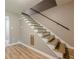 View of the staircase featuring wooden steps, handrail and neutral paint color at 5868 Kingswood Nw Ct, Norcross, GA 30093