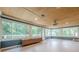 Bright sunroom featuring large windows offering scenic outdoor views and light toned wooden ceiling at 5868 Kingswood Nw Ct, Norcross, GA 30093