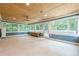 Sunroom with large windows offering scenic outdoor views and light toned wooden ceiling and neutral flooring at 5868 Kingswood Nw Ct, Norcross, GA 30093