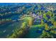 Scenic aerial view of a beautiful golf course, clubhouse, and lush landscaping nestled within a lovely neighborhood at 121 Clipper Bay Drive, Alpharetta, GA 30005