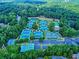 Aerial view of tennis courts surrounded by trees and parking lot at 121 Clipper Bay Drive, Alpharetta, GA 30005