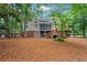 Lush backyard with mature trees and a wooden deck, perfect for outdoor living at 121 Clipper Bay Drive, Alpharetta, GA 30005