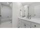 This bathroom features neutral wall and floor tiles, plus a shower-over-tub and vanity sink at 121 Clipper Bay Drive, Alpharetta, GA 30005