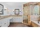 This bathroom includes double sinks, a granite countertop, and a shower featuring neutral-toned tile work at 121 Clipper Bay Drive, Alpharetta, GA 30005