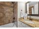The bathroom includes a shower-over-tub with a tiled backsplash and a vanity sink with a granite countertop at 121 Clipper Bay Drive, Alpharetta, GA 30005