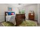 This bedroom features soft neutral walls, hardwood floors, and a classic dark-wood bed frame at 121 Clipper Bay Drive, Alpharetta, GA 30005