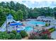 Beautiful community pool area with a water slide, lounge chairs, and shaded seating for residents at 121 Clipper Bay Drive, Alpharetta, GA 30005