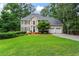 Beautiful two-story home with manicured lawn, attached two car garage, and mature trees at 121 Clipper Bay Drive, Alpharetta, GA 30005