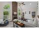 Bright living room features a stone fireplace, large windows, and hardwood floors at 121 Clipper Bay Drive, Alpharetta, GA 30005