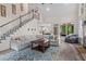 Open living room features a fireplace, large windows, and a staircase at 121 Clipper Bay Drive, Alpharetta, GA 30005