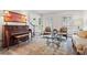Comfortable living room with piano, decorative rug, and large windows with natural light at 121 Clipper Bay Drive, Alpharetta, GA 30005