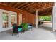 Covered brick patio with comfortable seating, ideal for outdoor enjoyment at 121 Clipper Bay Drive, Alpharetta, GA 30005