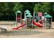 Community playground featuring slides, climbing structures, and swings, surrounded by a wood chip safety surface at 121 Clipper Bay Drive, Alpharetta, GA 30005