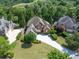 Stunning brick home with lush landscaping and a long driveway, nestled among mature trees in a desirable neighborhood at 1232 Everton Pl, Cumming, GA 30041