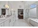 Elegant bathroom with double vanity, marble countertops, and a glass-enclosed shower and soaking tub at 1232 Everton Pl, Cumming, GA 30041