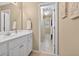 Bathroom with a white vanity, large mirror, and neutral walls at 1232 Everton Pl, Cumming, GA 30041
