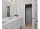 Bright bathroom featuring a white vanity, large mirror, and neutral color scheme at 1232 Everton Pl, Cumming, GA 30041