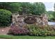 Stone community entrance sign surrounded by vibrant flowers and greenery, welcoming you to Edenham at Windermere at 1232 Everton Pl, Cumming, GA 30041