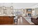 Open-concept living space featuring a stone fireplace and seamless flow into the kitchen area at 1232 Everton Pl, Cumming, GA 30041