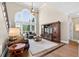 Comfortable living room with tall window, hardwood floors, and a vaulted ceiling at 1232 Everton Pl, Cumming, GA 30041