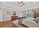 Inviting main bedroom featuring hardwood floors, a tray ceiling, and multiple windows at 1232 Everton Pl, Cumming, GA 30041