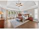 Spacious main bedroom with hardwood floors, tray ceilings, and ample natural light at 1232 Everton Pl, Cumming, GA 30041