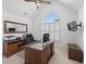 Bright home office with vaulted ceiling, large window, and ample desk space and wooden furniture at 1232 Everton Pl, Cumming, GA 30041
