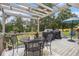 Back deck featuring patio furniture, an umbrella, and a grill, perfect for outdoor entertaining with wooded views at 1250 Timber Walk Dr, Loganville, GA 30052