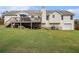 Backyard view showcasing a large, well-maintained lawn, wood fence, and a deck, perfect for outdoor enjoyment at 1250 Timber Walk Dr, Loganville, GA 30052